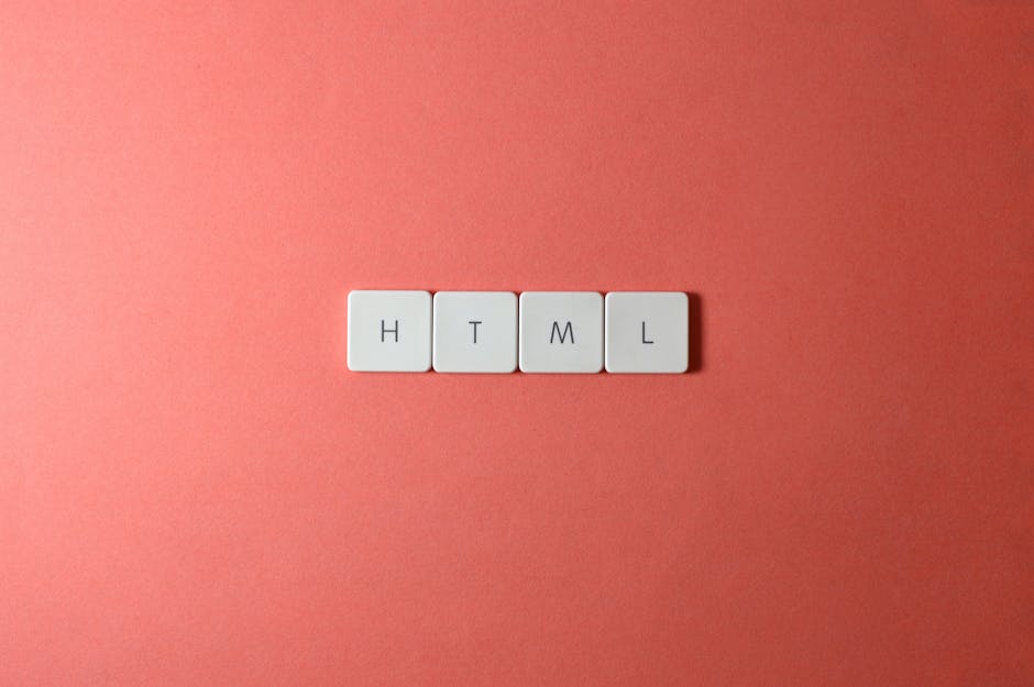 Four white keyboard keys arranged horizontally on a pinkish coral background, each labeled with a letter spelling out 'HTML.' The keys have a smooth matte finish with slightly rounded edges, and their
